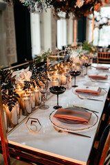 Elegant wedding table setting with candles and floral arrangements in luxurious decor