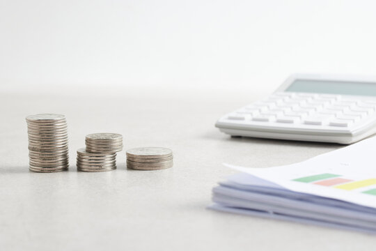 Coins and objects on a table with a financial and economic concept.