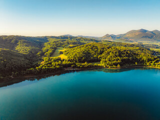Canoeing and sup standup paddleboarding at  mountains Ziros lake in Preveza Greece at sunrise.
