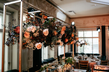 Elegant floral centerpiece in sophisticated banquet hall with luxurious decor and soft lighting ambiance
