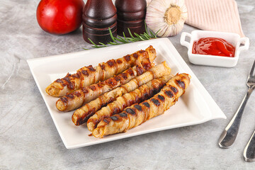 Grilled meat sausages wrapped bacon