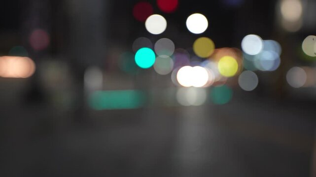 Blurred Pedestrians Crossing at Green Traffic Light with Bokeh Car Lights