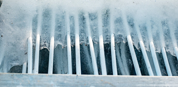 melted ice on the rink, freon pipes visible