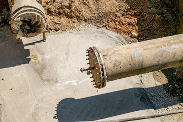 New plastic water pipeline in trench. Replacement of old rusty tubes by new one