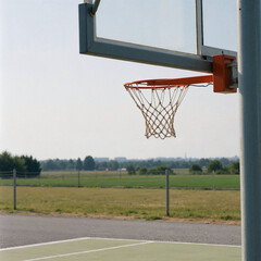 Basketball Hoop Overlooking a Peaceful Countryside Landscape