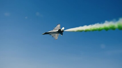 Fighter jet aerial display with green smoke trail at india independence day celebration symbol of national pride defense capability and technological advancement