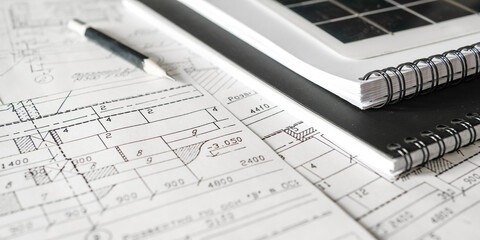 sustainable architecture tools and materials: blueprints, solar panel, wood textures, fabric...