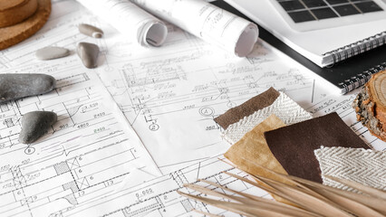 sustainable architecture tools and materials: blueprints, solar panel, wood textures, fabric...