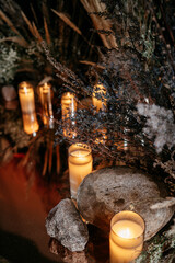 Candlelit woods: warm glow amidst stones and dried plants