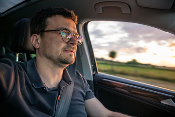 Man driving fast. Motion blur on highway. Sunset travel.