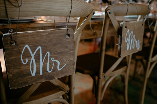 Rustic wedding chair signs for mr and mrs in elegant script