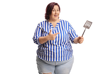 Woman holding a stainless steel kitchen turner