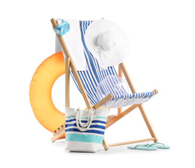 Striped deck chair, inflatable ring and beach accessories isolated on white background