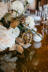 Elegant table setting with white flowers and gold decoration for special occasions