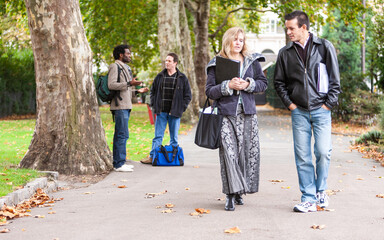 Adult Education: Walking to Class. A pair of mature students discussing their studies during a...