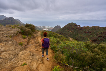 Tourist hiking rugged volcanic trail