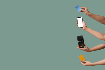 Female hands with mobile phone, payment terminal and credit cards on light turquoise background