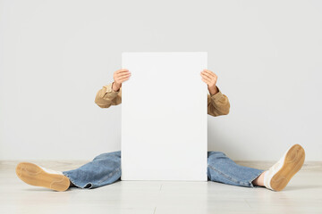 Young woman holding blank poster on white background
