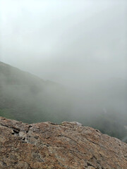 Gray stone podium on rock platform with green forest in soft daylight landscape scene  for product display