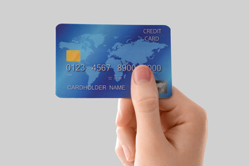 Female hand with credit card on white background, closeup