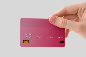 Female hand with credit card on white background, closeup