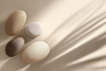 Natural stones arranged artistically on a soft surface with gentle shadows for a wellness brand flyer