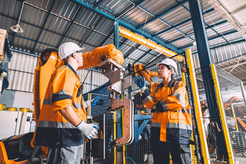 Engineer team service robot welding in automation factory. workers safety work robotic industry