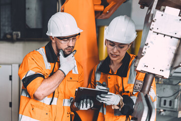 Engineer team service robot welding in automation factory. workers safety work robotic industry