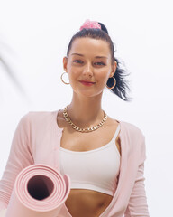 Confident Young Woman Holding Yoga Mat for Beachside Wellness Routine