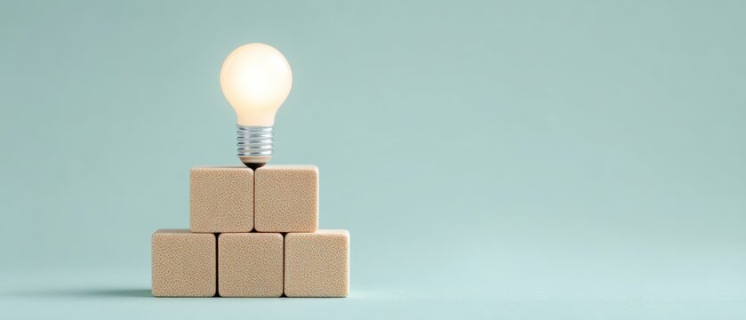 Illuminating ideas light bulb on wooden blocks creative workspace minimalist concept soft color palette