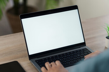Mockup blank screen computer with blank white background. hand man using laptop contact. advertising text, blank screen laptop, white table with white wall background