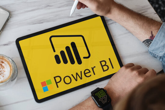 Businessman using microsoft power bi on tablet with stylus pen