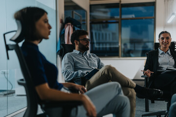 A diverse group of business people engaging in a late-night brainstorming session. The team...