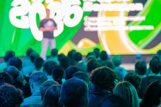 Bright conference scene with diverse audience engaged in dynamic colorful presentation environment