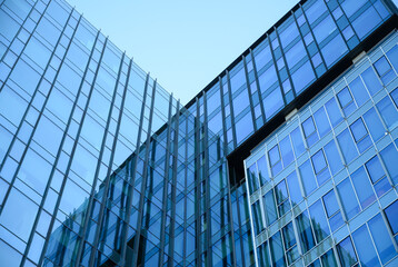 Abstract perspective of mirrored glass skyscrapers reflecting the blue sky. Ideal for finance, technology, or architectural visuals with futuristic vibes and dynamic lines. modern office building