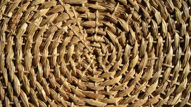 Woven straw circular pattern with textural detail and concentric rings.