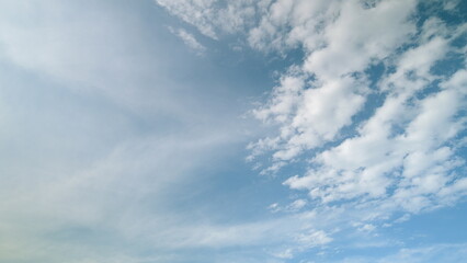 Time lapse. A beautiful and serene sky adorned with softly drifting and whispering clouds above us