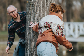 Two individuals are seen in a cheerful interaction outdoors, enjoying a lighthearted moment around...