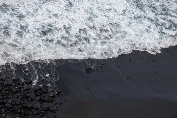 aerial view of a black sandy beach