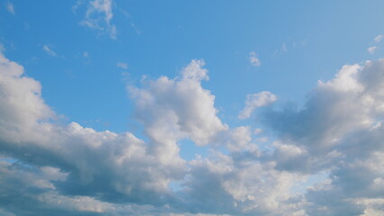 A Beautiful Sky filled with Fluffy Clouds against a Bright Blue Background, absolutely stunning