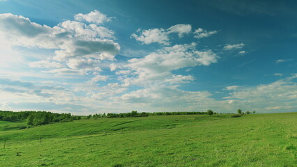 A Serene Green Landscape Awaits Beneath a Dramatic Cloudy Sky, Perfect for Exploration Time lapse.