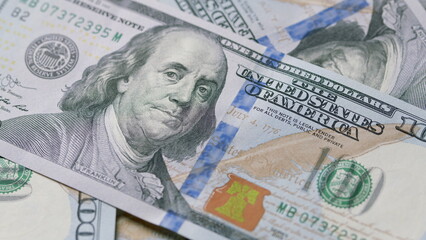 A CloseUp View of Various Hundred Dollar Bills Showing Their Intricate Design Details