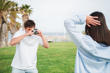 A young couple joyfully posing and taking photographs together, creating lasting memories with a...