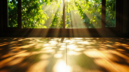Sunlight streaming through window onto wooden floor with green leaves and shadows creating a warm interior scene