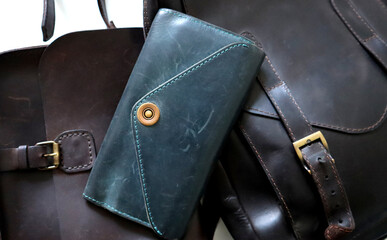 Wallet or handbag made of turquoise crazy horse leather. Leather goods on background. Texture of...