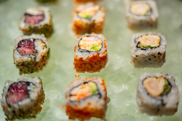 Assorted Sushi Rolls and Nigiri on Ice Display