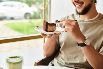 man enjoys a sweet break with matcha and cake at a sunny cafe