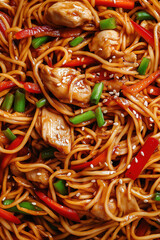 stir-fried noodles with chicken, vegetables, and sesame seeds, macro and full-frame texture shot, close-up texture, top view