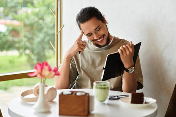 Creative man enjoying matcha while working remotely in a cafe