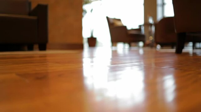 Reflective wood floor with sunlight in modern home interior setting